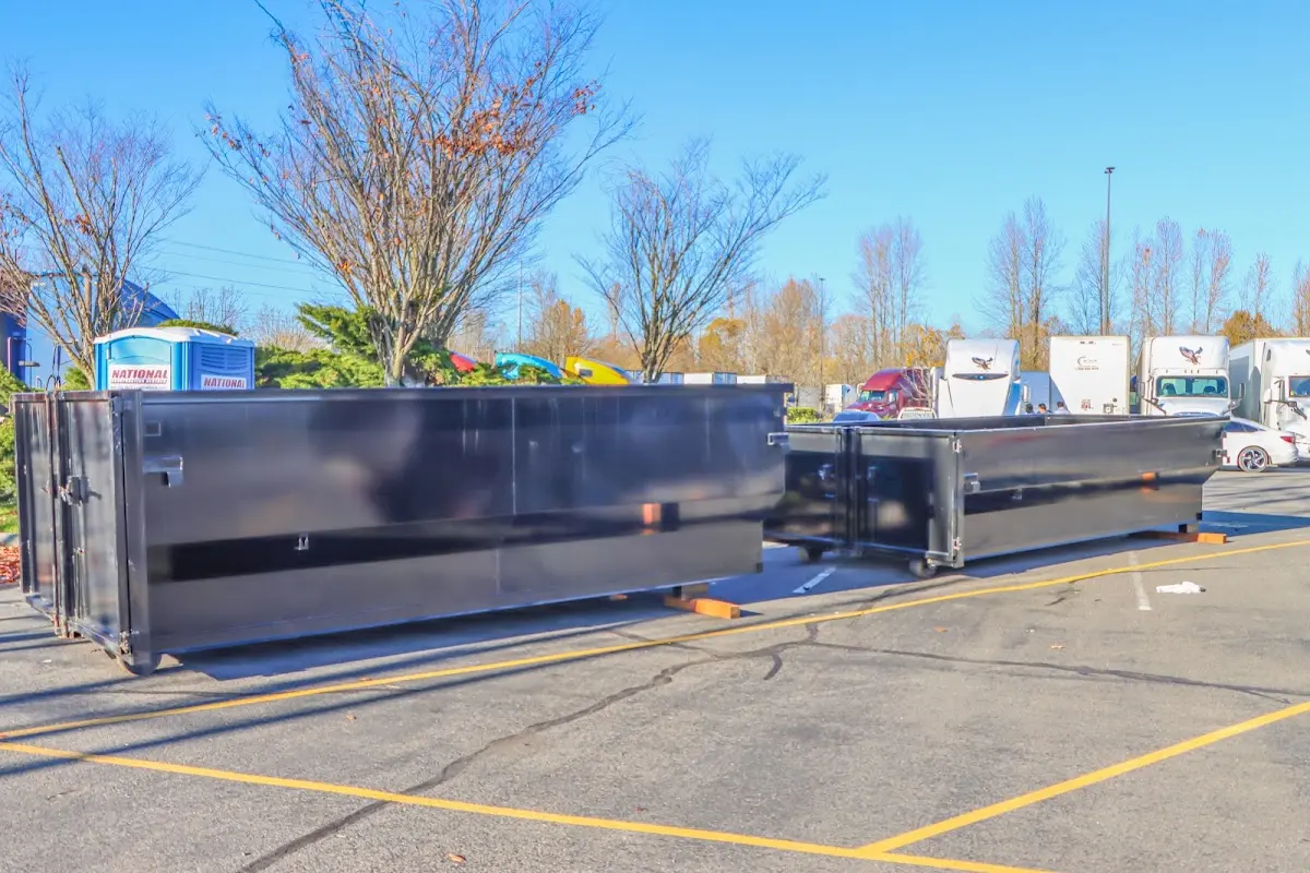 Professional dumpster rental service with roll-off container on residential driveway in Las Flores